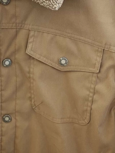 Detail of khaki canvas jacket with buttoned pocket and warm fleece lining for winter