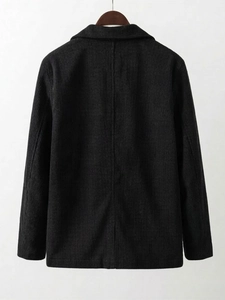 Detail view of the vertical corduroy texture and back design of a black casual blazer