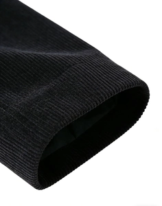 Macro shot of men's corduroy blazer cuff showing fine vertical texture and neat lining
