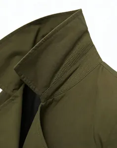 Detailed close-up of army green trench coat collar featuring precise multi-row stitching