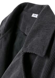 Macro shot of the charcoal grey corduroy blazer collar and inner lining texture