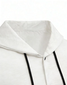 Close-up of white cotton linen shirt collar with black drawstring and button detail