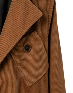 Detail of classic brown corduroy blazer showing wide lapel and pocket with button