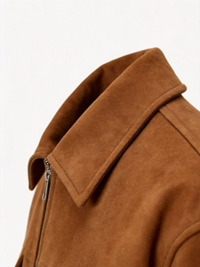 Detail of caramel suede jacket showing the classic collar and silver metal zipper
