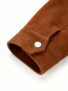 Close-up of brown suede jacket sleeve featuring silver metallic button and premium stitching