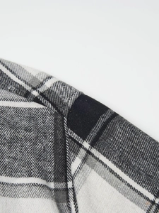 Close-up of black and white herringbone plaid flannel shirt showing fabric texture