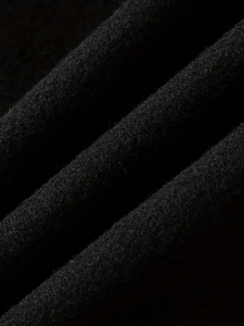 Close-up of premium black wool fabric texture on a men's classic single-breasted trench coat