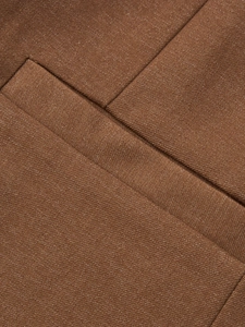 Detail of brown twill blazer fabric showing high-quality stitching and woven texture