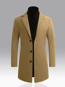 Detailed close-up of camel wool coat lapel with three dark brown resin buttons