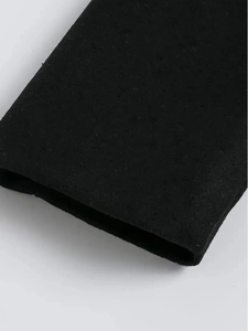 Detail of the high-density black knitted cuffs with premium fiber texture on the coat