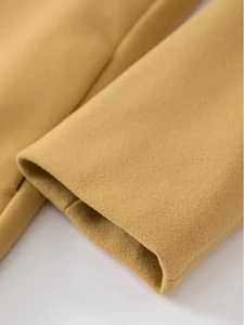Detailed close-up of the camel wool coat cuff showing premium fabric texture and stitching