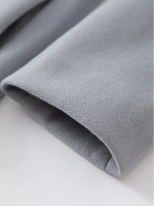 Close-up of cuff detail on gray wool blend trench coat showing premium fabric texture
