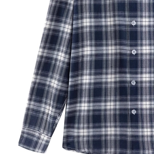 Close-up of classic blue and grey plaid long sleeve shirt with polished button details