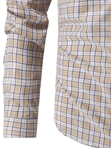 Detail shot of navy and beige plaid shirt sleeve showing precise stitching and fabric texture