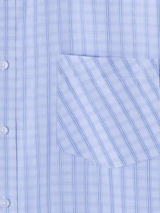 Detailed close-up of light blue plaid shirt pocket with bias-cut patterns and buttons