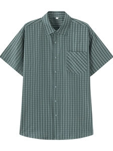 Detail shot of men's sage green button-down shirt with textured grid pattern and pocket