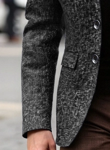 Detail view of men business casual blazer showing textured grey polyester fabric and button
