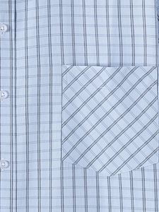 Detail of light blue plaid shirt fabric with white buttons and diagonal chest pocket