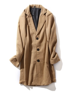 Detail of camel wool overcoat showing classic lapels and black button closure