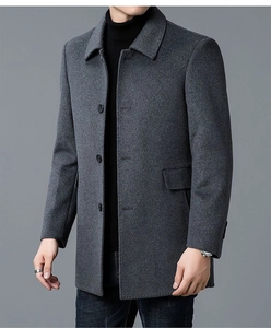Detail of classic dark grey wool coat featuring notched lapels and button closure texture