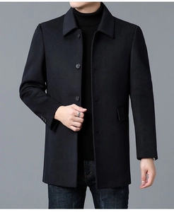 Detailed close-up of a men's black wool overcoat featuring high-quality buttons and lapel