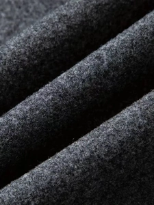 Close-up of premium dark grey wool fabric texture showing the thick winter coat material