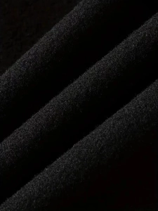 Macro shot of high-quality black wool fabric texture on a long slim fit men's overcoat