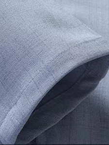 Detailed close-up of stitching on light blue cotton-linen blend casual blazer