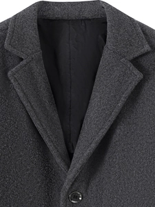 Detail of dark grey wool blazer collar with notch lapel and high-quality fabric texture