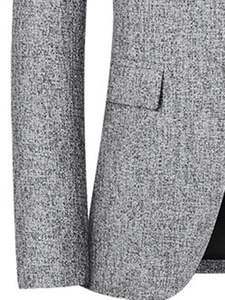 Detailed view of grey textured tweed fabric and flap pocket on a slim fit men blazer