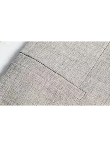 Close-up of pocket stitching and fine grey plaid fabric on men's tailored blazer