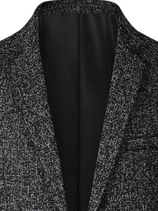 Detail of dark grey textured fabric on men's slim fit jacket with notched lapel