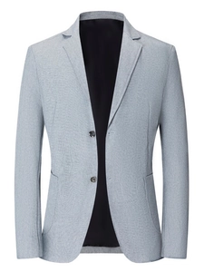 Close-up of texture on a men's light blue blazer with classic notch lapels and buttons