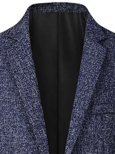 Close-up of slim-fit men blazer showing blue and white woven fabric texture with black lining