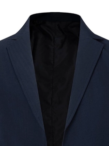 Detailed close-up of dark blue notched lapel suit with fine textured fabric and lining