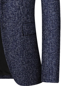 Detail of blue textured suit jacket featuring side flap pocket and grainy tweed fabric