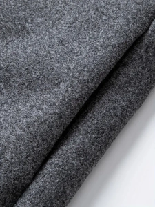Close-up of thick dark grey wool blend fabric texture for men's overcoat detail