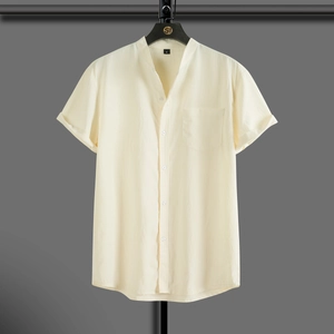 Detail of light yellow men's Henley shirt with textured fabric and chest pocket