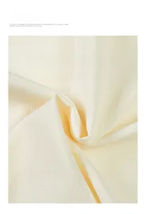 Macro shot of breathable ivory textured fabric with natural vertical crinkled pattern