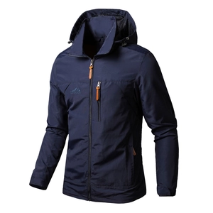 Detail view of navy blue windproof outdoor hooded jacket with embroidered logo and orange zipper pull