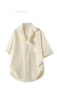 Detail of cream short sleeve shirt featuring high-quality seersucker textured fabric