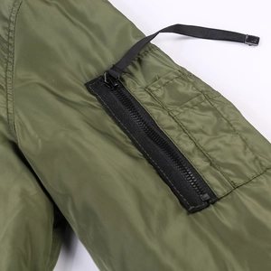 Men's olive bomber jacket sleeve detail with utility pocket and black zippers