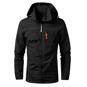 Detail of black outdoor hooded jacket featuring water-resistant fabric and orange zipper pull