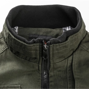 Detail of army green cotton jacket showing stand collar, metal zipper, and plaid lining