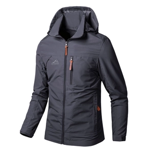 Detail of grey hooded windbreaker featuring a zippered chest pocket and outdoor mountain logo