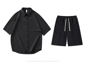 Détail d'une chemise noire texturée à manches courtes et d'un short assorti à cordon