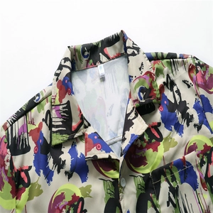 Detailed view of the lapel collar and abstract graffiti print on a men's casual shirt