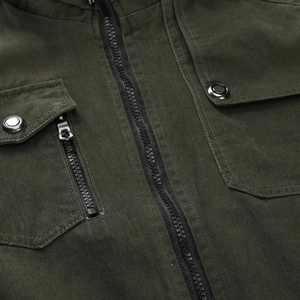 Close-up of military green cotton jacket showing metal zippers and premium stitching