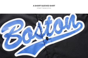 Detail shot of the Boston print on a black polo shirt with white outlined blue letters