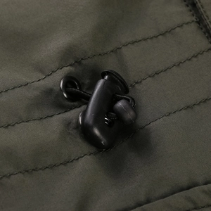 Detailed view of the adjustable drawstring system and metal eyelet on army green jacket